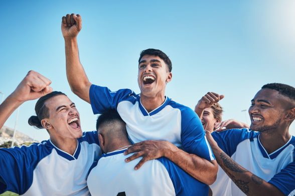 sports-team teammates cheer after winning a game